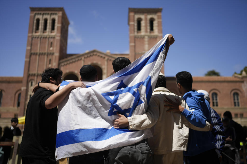 Pro-Israeli demonstrators gather near a Pro-Palestinian encampment on the UCLA campus Thursday, April 25, 2024, in Los Angeles. (AP Photo/Jae C. Hong)