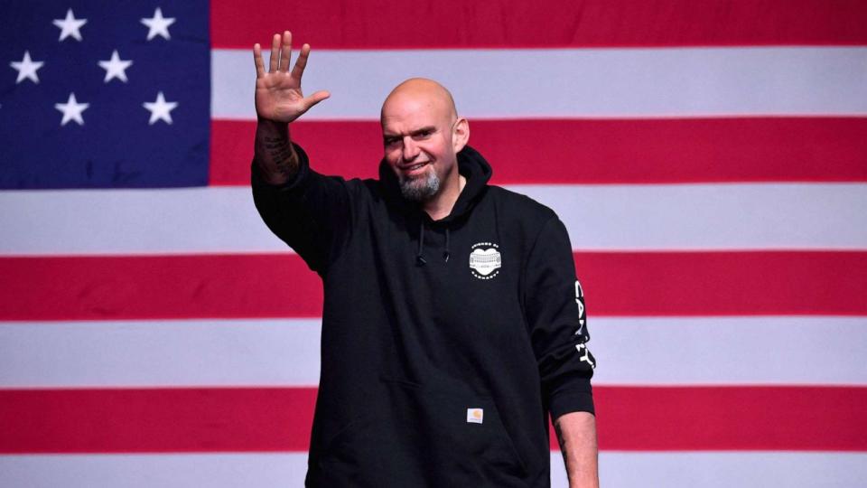 PHOTO: Pennsylvania Democratic Senatorial candidate John Fetterman waves onstage at a watch party during the midterm elections at Stage AE in Pittsburgh, PA, on Nov 8, 2022. (Angela Weiss/AFP via Getty Images)