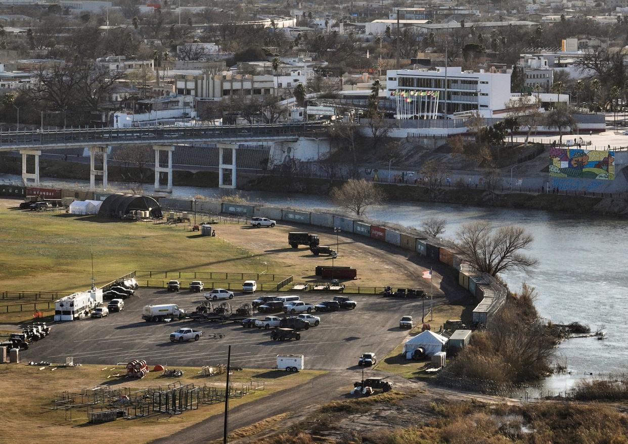 Shipping containers and concertina wire line the banks of the Rio Grande, in Shelby Park in Eagle Pass, Texas, across the border from Piedras Negras, Mexico, Sunday, Feb. 4, 2024. (Jay Janner/Austin American-Statesman via AP)