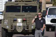 An FBI armored vehicle leaves the scene of a deadly shooting early Monday, March 30, 2020, in Phoenix. Phoenix police say one of their commanders was killed and two other officers were wounded as they responded to a domestic dispute. Authorities say Cmdr. Greg Carnicle and officers were called to a home in the northern part of Phoenix Sunday night over a roommate dispute when the suspect refused to cooperate and shot them. The suspect was not identified and was pronounced dead at the scene. (AP Photo/Matt York)