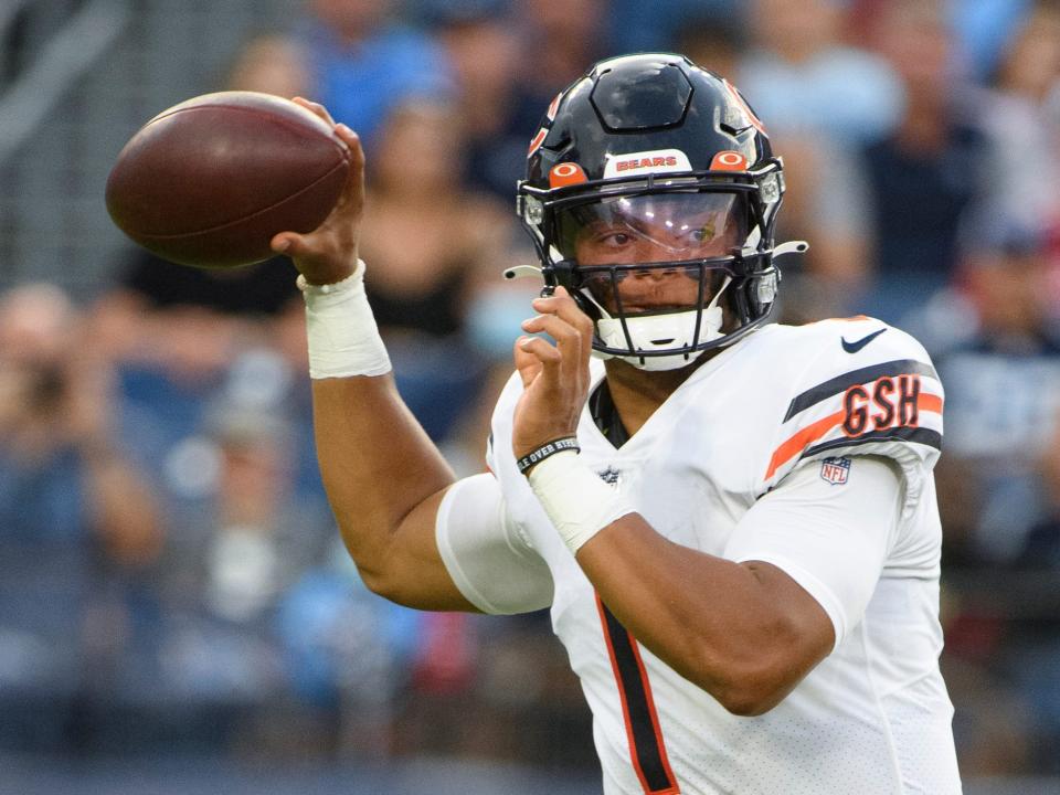 Justin Fields throws a pass during a preseason game.