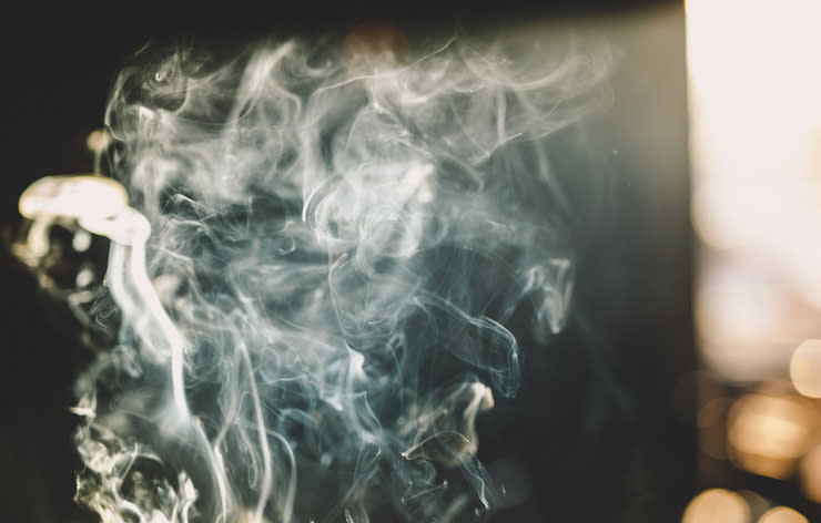 Smoke swirling in the air against a dark background