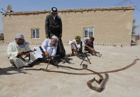 Shi'ite volunteers, who have joined the Iraqi army to fight against the predominantly Sunni militants from the radical Islamic State, formerly known as the Islamic State of Iraq and the Levant (ISIL), take part in weapons training in Najaf, July 18, 2014. REUTERS/Alaa Al-Marjani