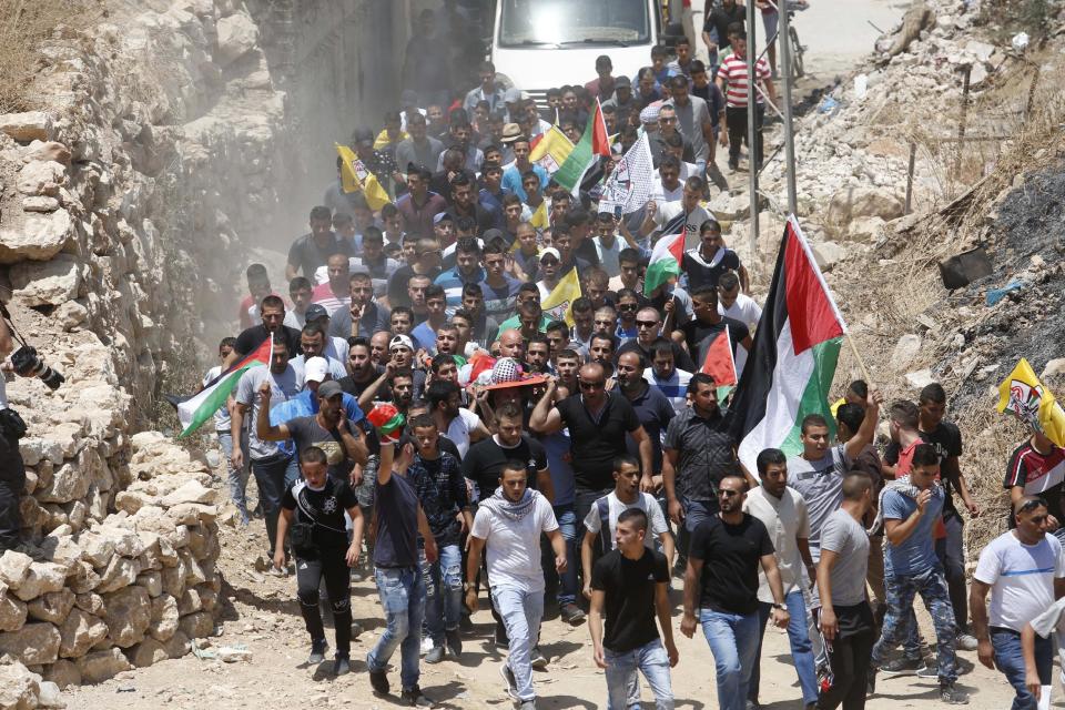 FILE - Mourners carry the body of Muhey al-Tabakhi, 12, during his funeral in the West Bank town of Al-Ram, near Jerusalem, Wednesday, July 20, 2016. A Palestinian hospital official says the boy was killed after clashes erupted between Israeli forces and protesters in the West Bank. Ramallah hospital director Ahmad Bitawi says the boy was killed by a bullet to the chest. Israeli police deny that live fire was used against protesters.(AP Photo/Nasser Shiyoukhi, File)