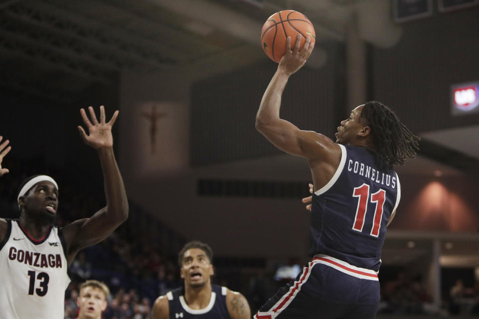 Jackson State guard Keionte Cornelius (11) shoots while pressured by Gonzaga forward Graham Ike (13) during the first half of an NCAA college basketball game, Wednesday, Dec. 20, 2023, in Spokane, Wash. (AP Photo/Young Kwak)
