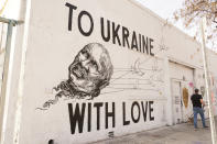 A mural titled "To Ukraine with Love" by street artist Corie Mattie is seen in the Arts District of downtown Los Angeles, on Monday, March 21, 2022. Artist Mattie collaborated to raise money for war victims with tattoo artist Juliano Trindade on their mural of the head of Russian President Vladimir Putin being carried away by doves. (AP Photo/Eugene Garcia)