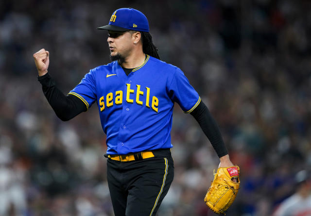 Seattle Mariners' Ty France holds a trident in the dugout after hitting a  solo home run against the Baltimore Orioles during the fifth inning of a  baseball game Friday, Aug. 11, 2023