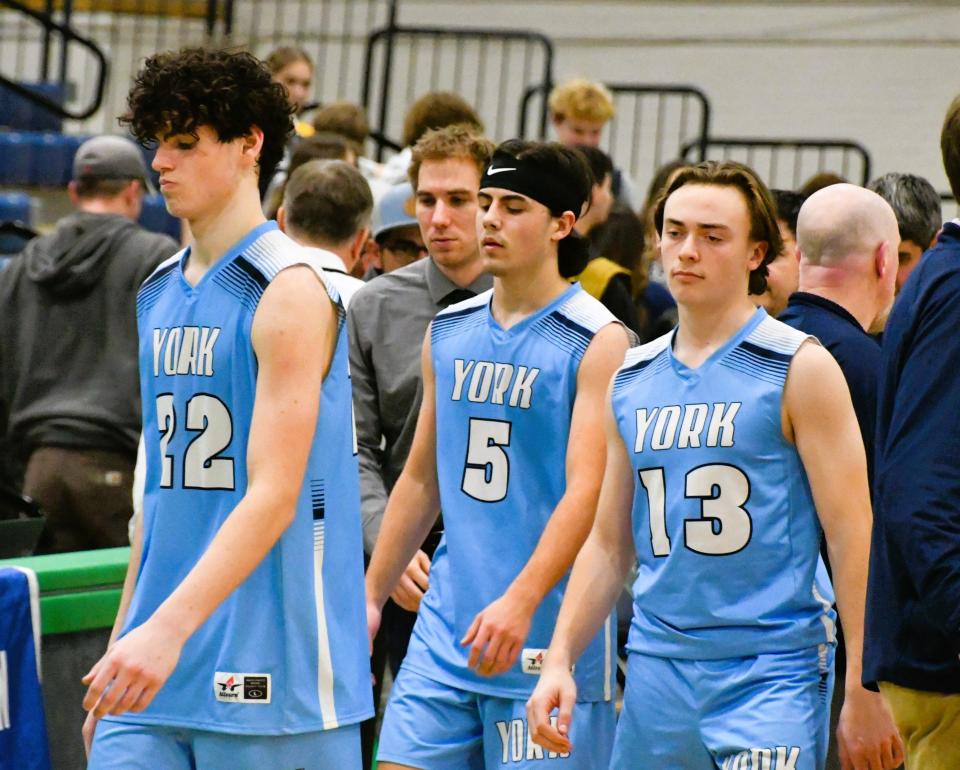 The body language tells the story for the York High School boys basketball team. York’s Lukas Bouchard, left, Jake Fogg and Ben Brown walk off the floor at the Portland Expo after Friday night’s 66-61 loss to Medomak Valley.