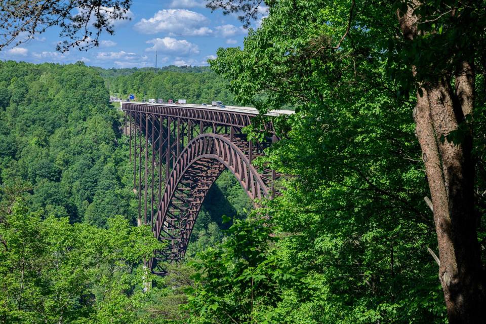 <p><strong>New River Gorge Bridge</strong></p><p>The <a href="https://www.nps.gov/neri/planyourvisit/nrgbridge.htm" rel="nofollow noopener" target="_blank" data-ylk="slk:New River Gorge Bridge;elm:context_link;itc:0;sec:content-canvas" class="link ">New River Gorge Bridge</a> is a steel arch bridge that spans 3,030 feet long over the New River Gorge near Fayetteville, West Virginia. For 26 years, it was the world’s longest single-span arch at 1,700 feet long, but now sits at the number four spot. Located in the Appalachian Mountains it defines taking the scenic route.</p>