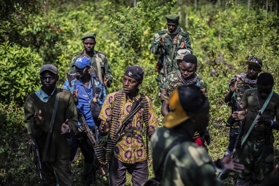 Armed militiamen gather near Rutshuru, 70 kms (45 miles) north of Goma, Democratic Republic of Congo,Wednesday June 22, 2022. Earlier in the week, East Africa's leaders have responded to the threat of war between Rwanda and Congo by instructing a new regional force to deploy in eastern Congo and ordering an immediate cease-fire. A statement after the meeting in Kenya's capital does not give details on the date of deployment of the force or its composition. (AP Photo/Moses Sawasawa)