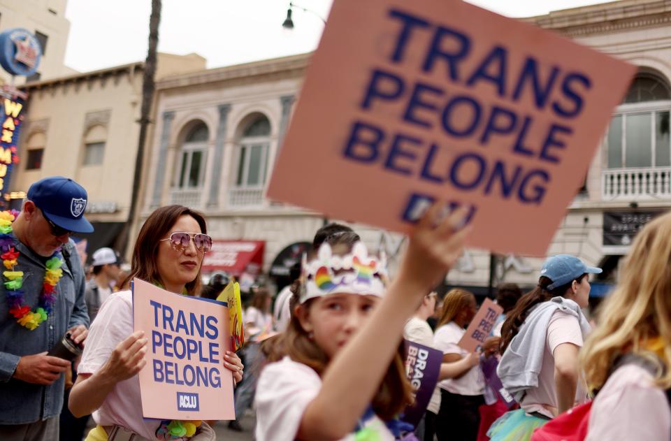 ACLU march participants carry signs in support of rights for transgender people during the 2023 LA Pride Parade in Hollywood on June 11, 2023 in Los Angeles, California.