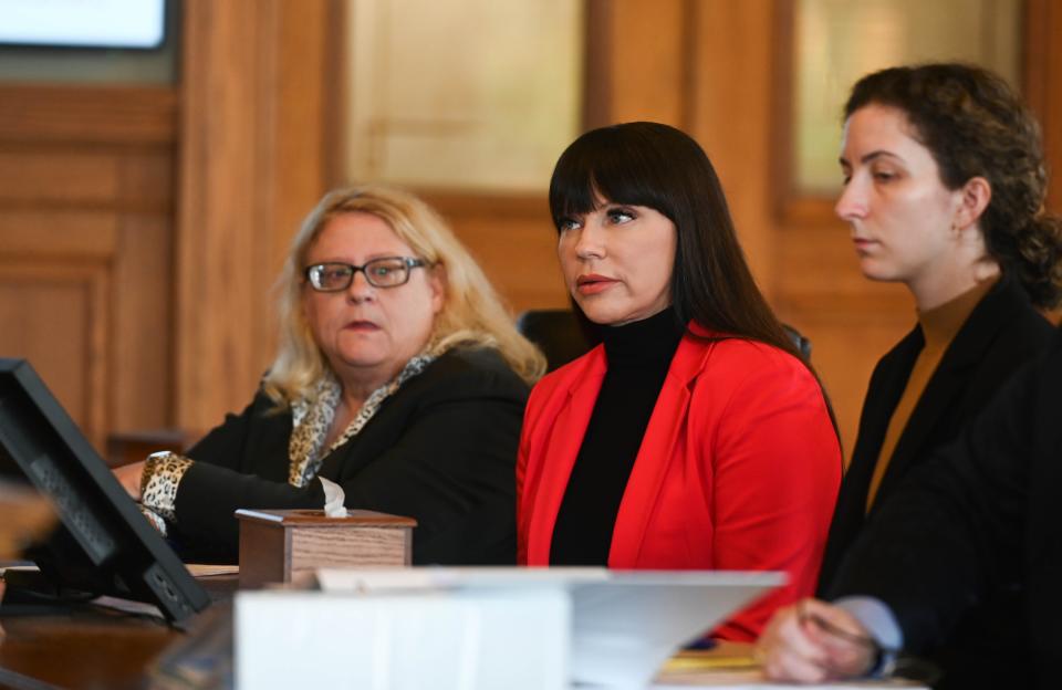 Brenda Tracy, middle, is flanked by members of her legal team, Karen Truszkowski, left, and Gina Goldfaden, as she addressess Judge Rosemarie Aquilina at the Ingham County Circuit Court in downtown Mason, Thursday, Oct. 26, 2023.