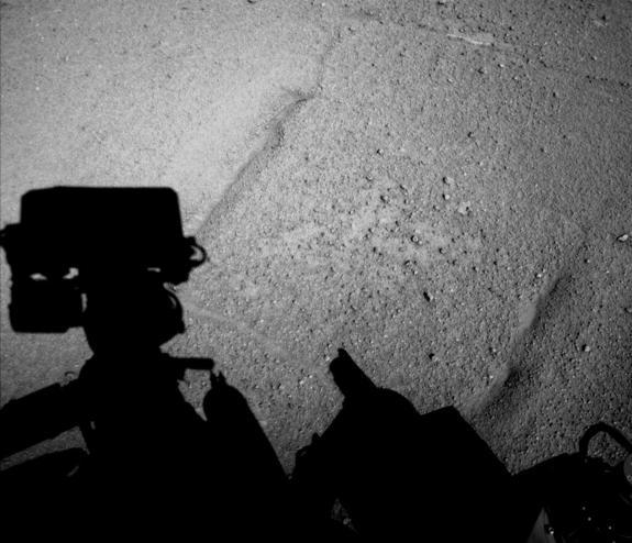 NASA's Curiosity Mars rover caught its own shadow in this image taken just after completing a backward drive of 329 feet (100.3 meters) on the 547th Martian day, or sol, of the rover's work on Mars (Feb. 18, 2014).