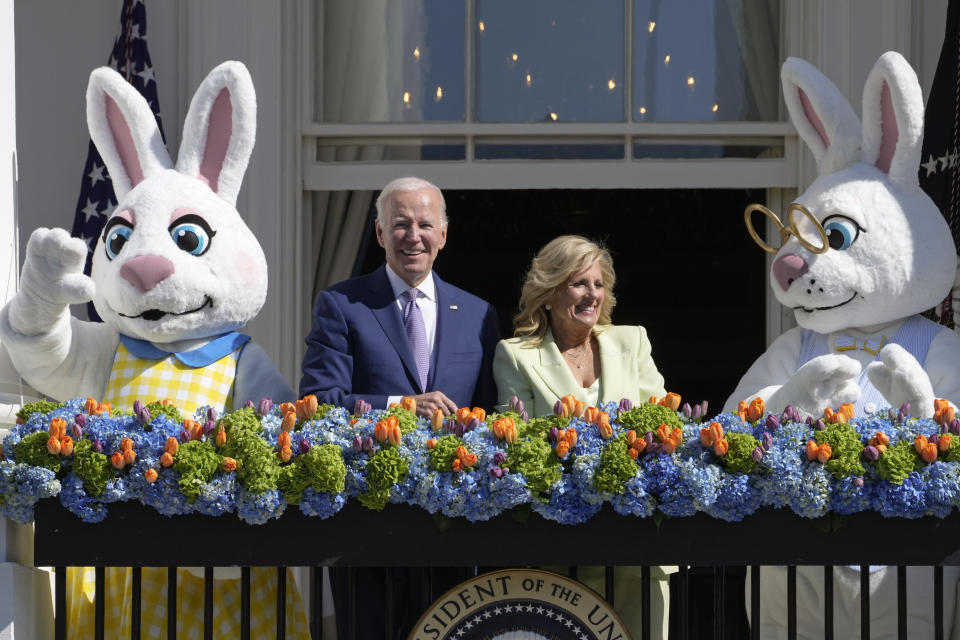 President Joe Biden and first lady Jill Biden look out at the crowd from the Blue Room Balcony as they attend the 2023 White House Easter Egg Roll, Monday, April 10, 2023, in Washington. (AP Photo/Susan Walsh)