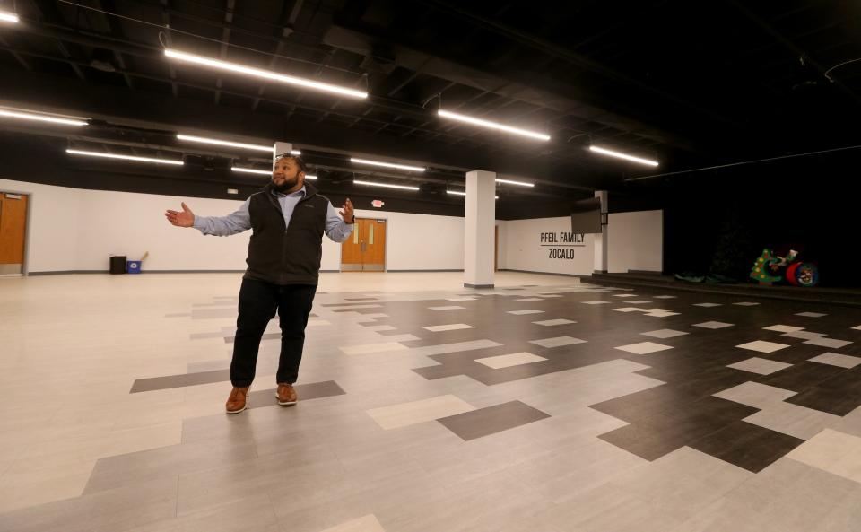 Executive Director Juan Constantino shows off the large Zocalo gathering space with a stage Dec. 7, 2022, in the lower level at La Casa de Amistad on South Michigan Street in South Bend.