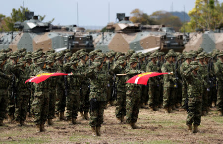 Soldiers of Japanese Ground Self-Defense Force (JGSDF)'s Amphibious Rapid Deployment Brigade, Japan's first marine unit since World War Two, attend a ceremony activating the brigade at JGSDF's Camp Ainoura in Sasebo, on the southwest island of Kyushu, Japan April 7, 2018. REUTERS/Issei Kato
