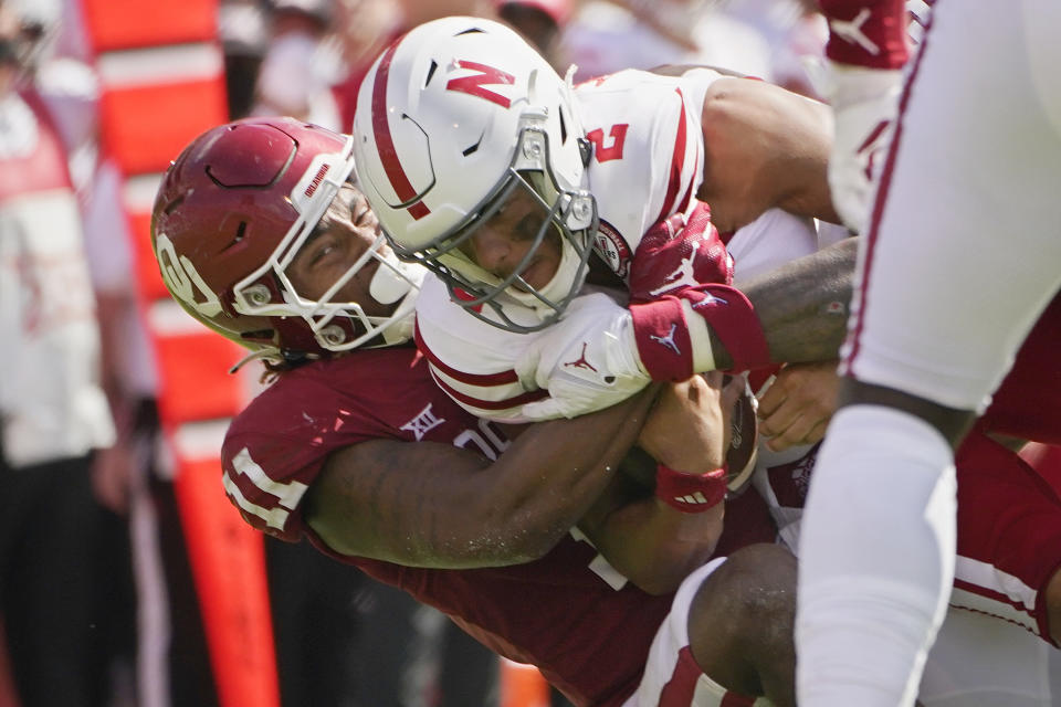 Oklahoma linebacker Nik Bonitto (11) sacks Nebraska quarterback Adrian Martinez (2), in the second half of an NCAA college football game, Saturday, Sept. 18, 2021, in Norman, Okla. (AP Photo/Sue Ogrocki)