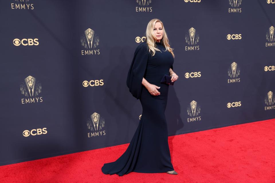 Jennifer Coolidge in a long-sleeved navy Christian Siriano gown.