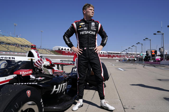 FILE - Josef Newgarden stands next to his car after qualifying for an IndyCar Series auto race, Saturday, July 23, 2022, at Iowa Speedway in Newton, Iowa. The first episode of “100 Days to Indy” featured a behind the scenes look at the IndyCar series, personalities and even a shirtless star Josef Newgarden. (AP Photo/Charlie Neibergall, File)