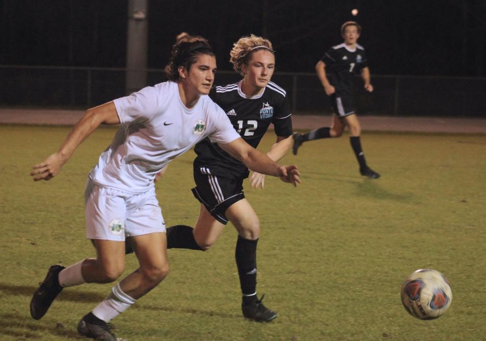 Nease forward Brogan Donnelly (18) and Ponte Vedra defender Jack Lopez (12) race for the loose ball  during an FHSAA District 3-6A boys soccer semifinal on January 30, 2023. [Clayton Freeman/Florida Times-Union]