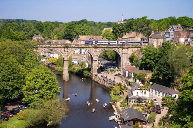 People row boats underneath the Knaresborough Viaduct 