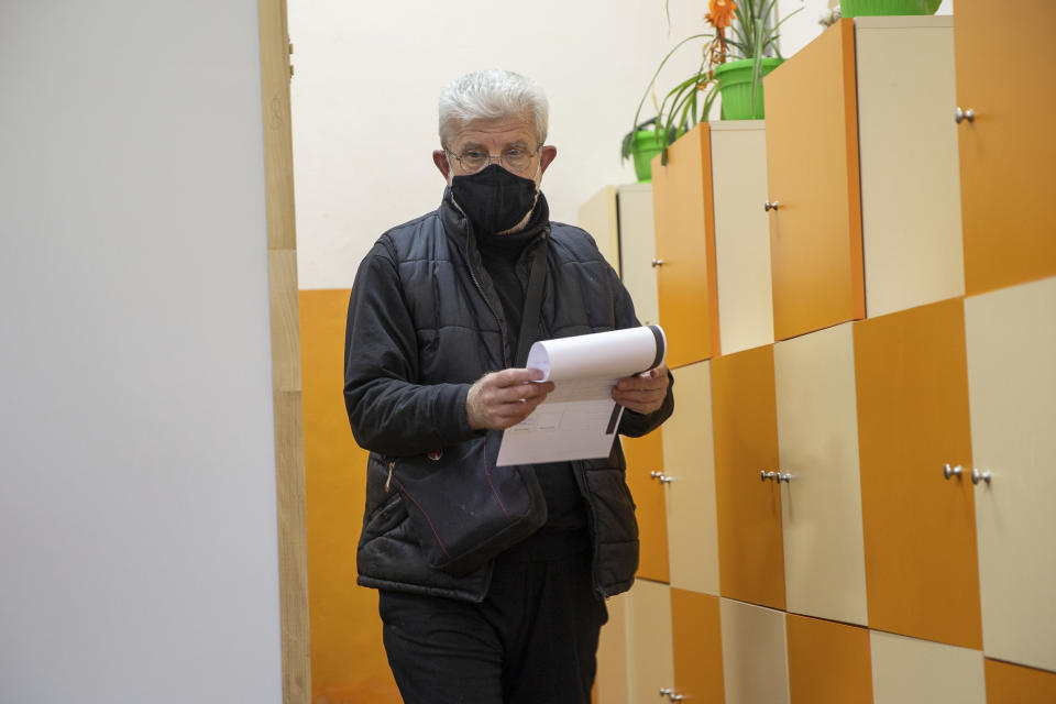 A man holds his ballot during parliamentary elections in the town of during the parliamentary elections in the town of Bankya, Bulgaria, Sunday, April 4, 2021. Bulgarians are heading to the polls on Sunday to cast ballots for a new parliament after months of anti-government protests and amid a surge of coronavirus infections. (AP Photo/Visar Kryeziu)