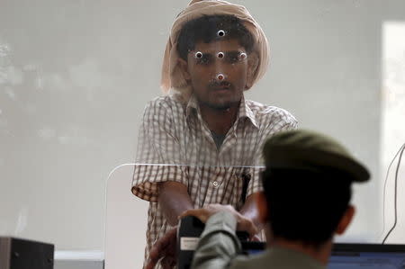 A Yemeni man entering Saudi Arabia waits to stamp his passport at Al-Tiwal crossing in Jizan on Saudi Arabia's border with Yemen, April 7, 2015. REUTERS/Faisal Al Nasser