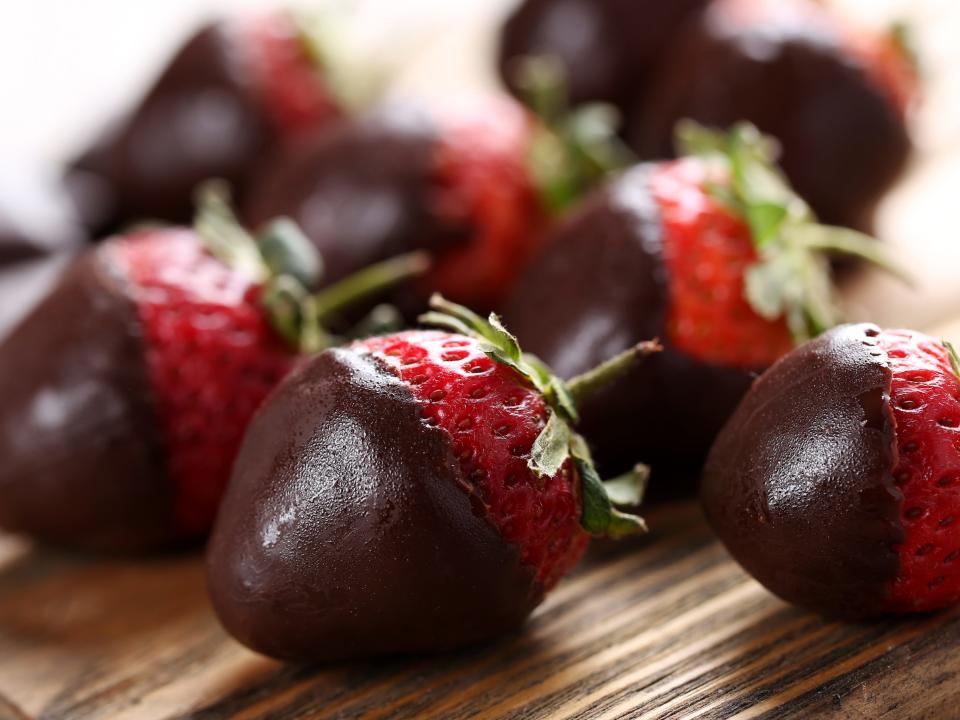 chocolate covered strawberries on a wooden board