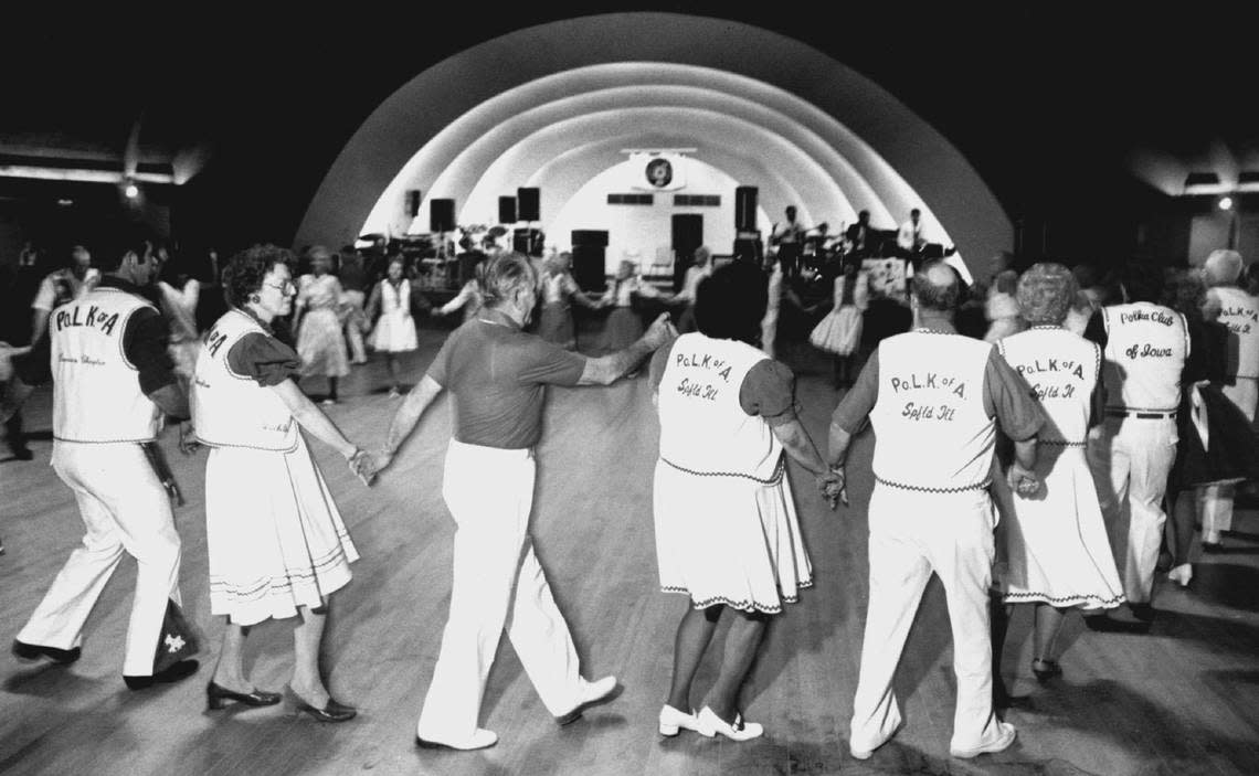 Polka dancers join hands for a circle dance at the Cotillion in this vintage photo.