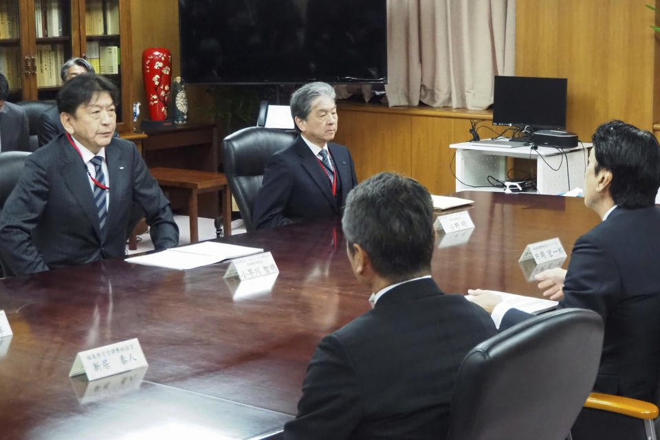 Tokyo Electric Power Company Holdings (TEPCO) President Tomoaki Kobayakawa, left, holds a meeting with Japan's Industry Minister Ken Saito, right, at the Ministry of Economy, Trade and Industry in Tokyo Wednesday, Feb. 21, 2024. Japan’s industry minister summoned the president of the utility that runs the Fukushima nuclear power plant to his office Wednesday and chided him for a radioactive water leak at the plant earlier this month. (Kyodo News via AP)