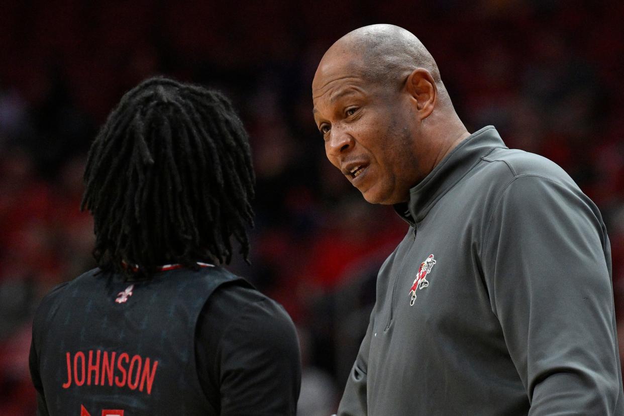 Feb 3, 2024; Louisville, Kentucky, USA; Louisville Cardinals head coach Kenny Payne talks with guard Ty-Laur Johnson (4) during the first half against the Florida State Seminoles at KFC Yum! Center. Mandatory Credit: Jamie Rhodes-USA TODAY Sports