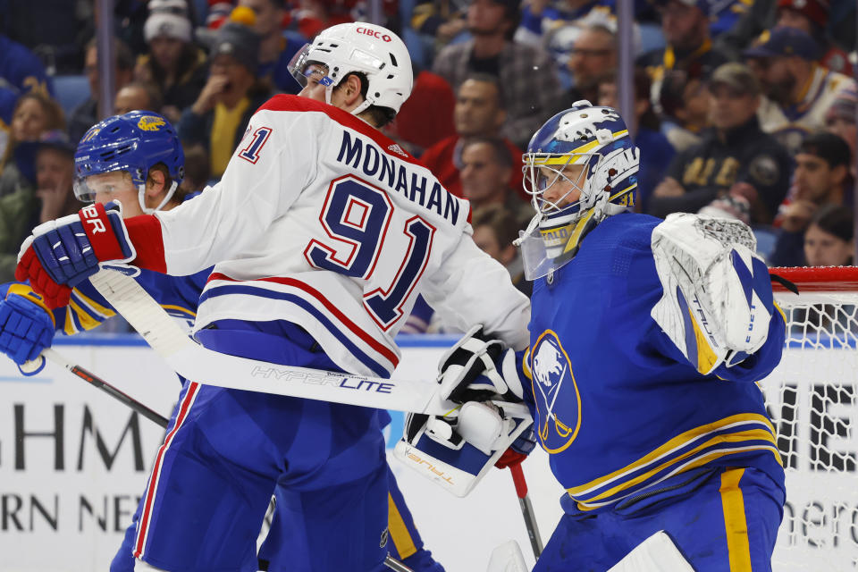 Montreal Canadiens center Sean Monahan (91) collides with Buffalo Sabres goaltender Eric Comrie (31) during the second period of an NHL hockey game, Thursday, Oct. 27, 2022, in Buffalo, N.Y. (AP Photo/Jeffrey T. Barnes)