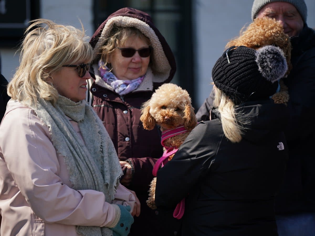 Wellwishers at the Walnut Tree Pub in Aldington, Kent, as they wait for Paul O'Grady's funeral cortege (PA)