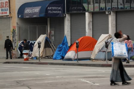 Tents and tarps erected by homeless people are shown along the sidewalks in the skid row area of downtown Los Angeles, California