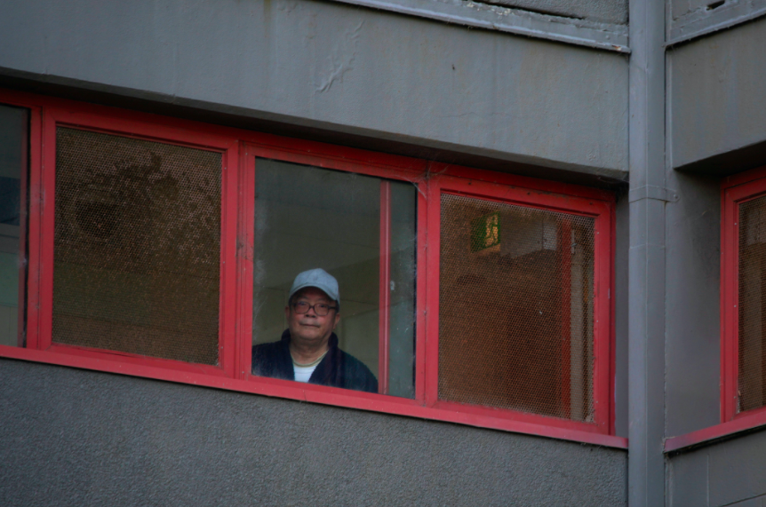 A resident looks out of his window as authorities in Melbourne keep people inside during lockdown. (Reuters)