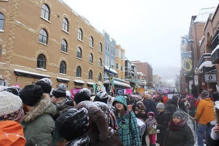 Protesters against new U.S. President Donald Trump march down Park City's Main Street during the Sundance Film Festival, in solidarity with the Women's March protests being held around the world, in Park City, Utah, U.S. January 21, 2017. REUTERS/Piya Sinha-Roy