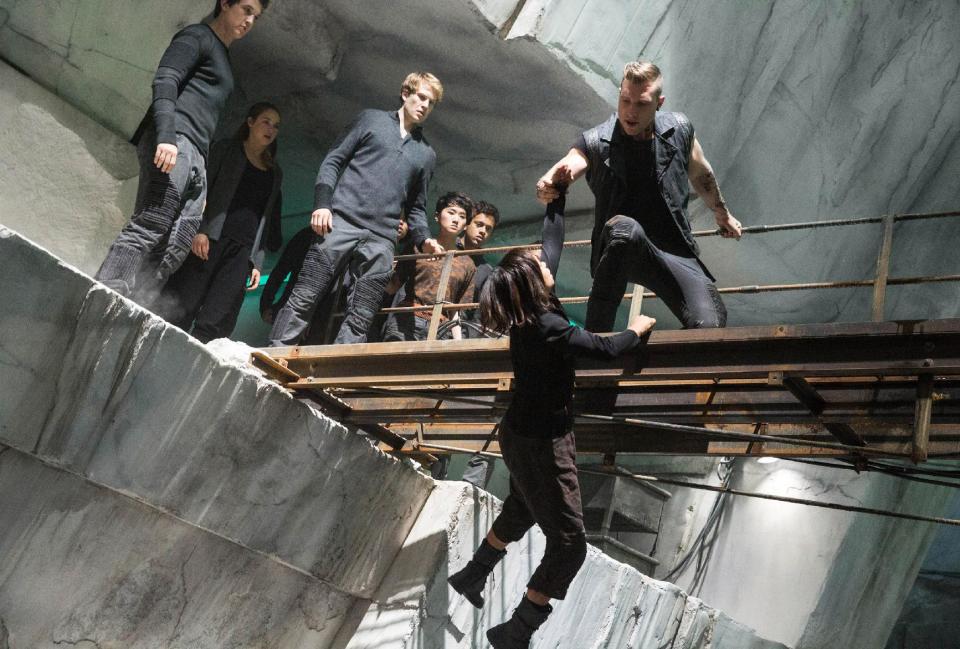 This photo released by Summit Entertainment shows, from left, Miles Teller, Shailene Woodley, Ben Lamb, Zoe Kravitz, and Jai Courtney, in a scene from the film, "Divergent." The film releases on Friday, March 21, 2014. (AP Photo/Summit Entertainment, Jaap Buitendijk)
