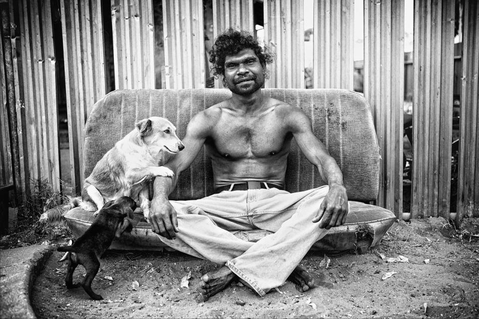 “Alcohol can bring you down and kill you, it will….to me I was happy to die, I lost my father he was my hero, I had a bad record , I know now my job is to save my people.” ‘Billy’ Stuart Ah Choo sitting outside his home in Kennedy Hill with his beloved dog Dontee and her pup Little Blacky. Broome, Western Australia. (Photograph by Ingetje Tadros/Diimex)