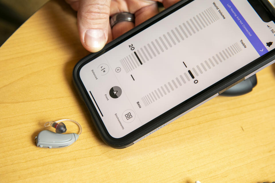 Sterling Sheffield, an assistant professor of Speech, Language, and Hearing Sciences at the University of Florida, shows an iPhone app that controls a Bose hearing aid Wednesday, Nov. 30, 2022, in Gainesville, Fla. OTC hearing aids started hitting the market in October afterthe FDA approved themfor adults with mild-to-moderate hearing loss, and Sheffield has been testing them. (AP Photo/Alan Youngblood)