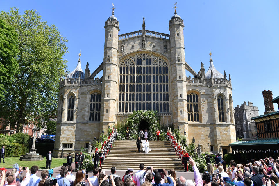 Britain's Prince Harry, Duke of Sussex and his wife Meghan, Duchess of Sussex leave from the West Door of St George's Chapel, Windsor Castle.