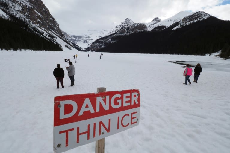 Visitors walk on frozen Lake Louise at Banff National Park in Alberta. The government has increased funding for Parks Canada but critics accuse the government agency of putting commercial interests first in recent years