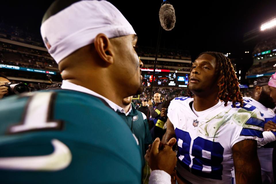 Philadelphia Eagles quarterback Jalen Hurts (1) talks with Dallas Cowboys wide receiver CeeDee Lamb (88) after their NFL football game, Sunday, Oct. 16, 2022, in Philadelphia. (AP Photo/Rich Schultz)