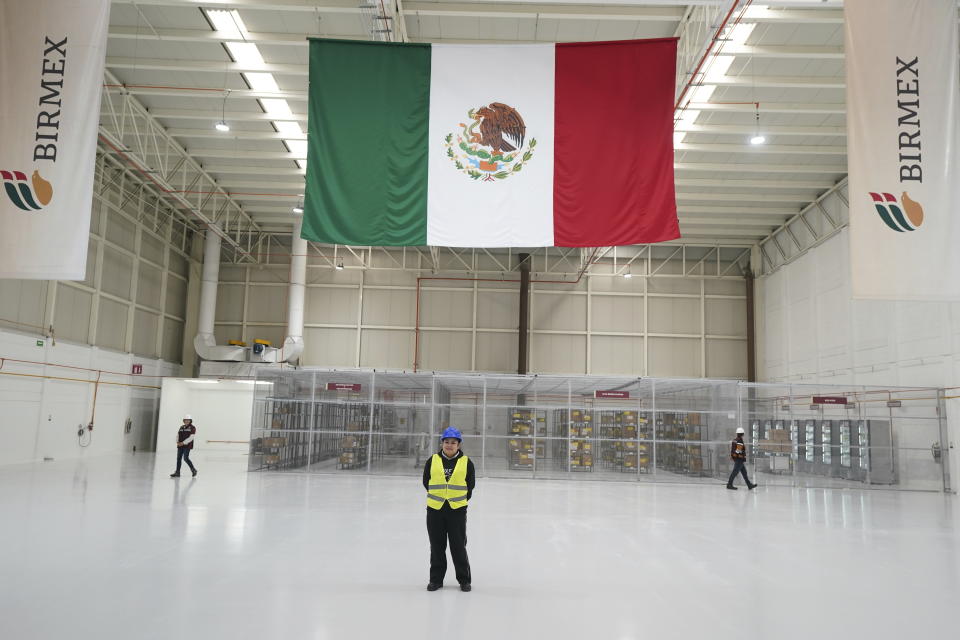 Workers stand inside a "mega-pharmacy" warehouse on its inauguration day in Huehuetoca, Mexico, Friday, Dec. 29, 2023. It is Mexican President Andrés Manuel López Obrador's solution to help end a supply issue for hospitals that don't have specific medicines needed by patients. (AP Photo/Fernando Llano)