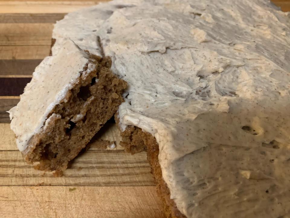 cooked trader joe's gingerbread loaf with icing on wooden cutting board