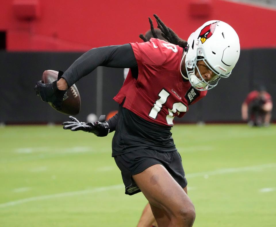 Arizona Cardinals DeAndre Hopkins (10) catches a pass behind his back during training camp at State Farm Stadium in Glendale on July 27, 2022.