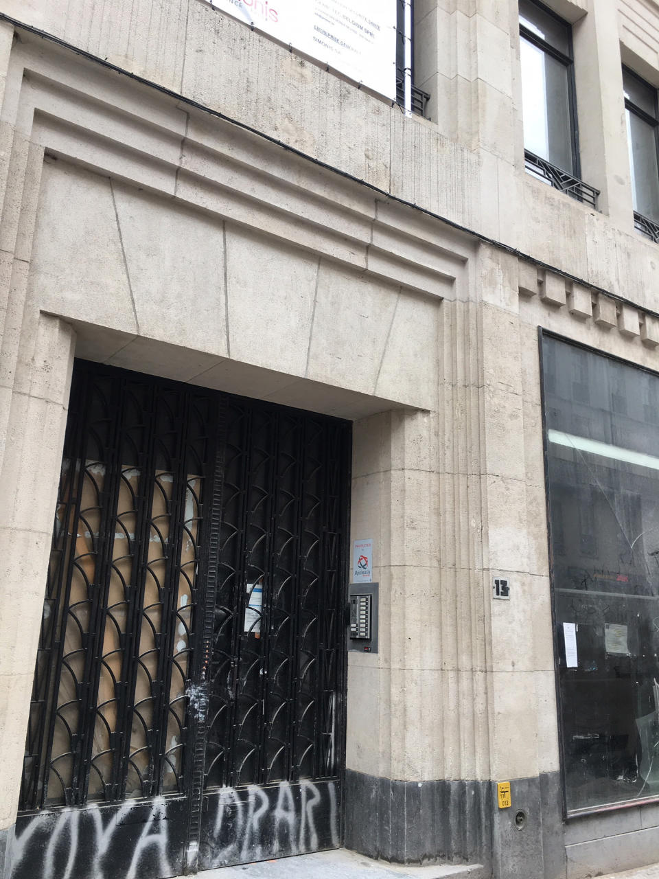This Tuesday, Feb. 5, 2019 photo shows the exterior of the address Rue des Poissonniers 13 in Brussels. The boarded-up building was supposedly the home of Mertens-Giraud Partners Management, but an Associated Press investigation has found that the firm is little more than a front for an elaborate undercover operation targeting security researchers, lawyers and a journalist. (AP Photo/Sylvain Plazy)
