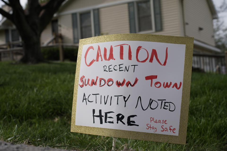 A sign is seen, Wednesday, April 19, 2023, in front of the house where 84-year-old Andrew Lester shot 16-year-old Ralph Yarl a week earlier in Kansas City, Mo. (AP Photo/Charlie Riedel)