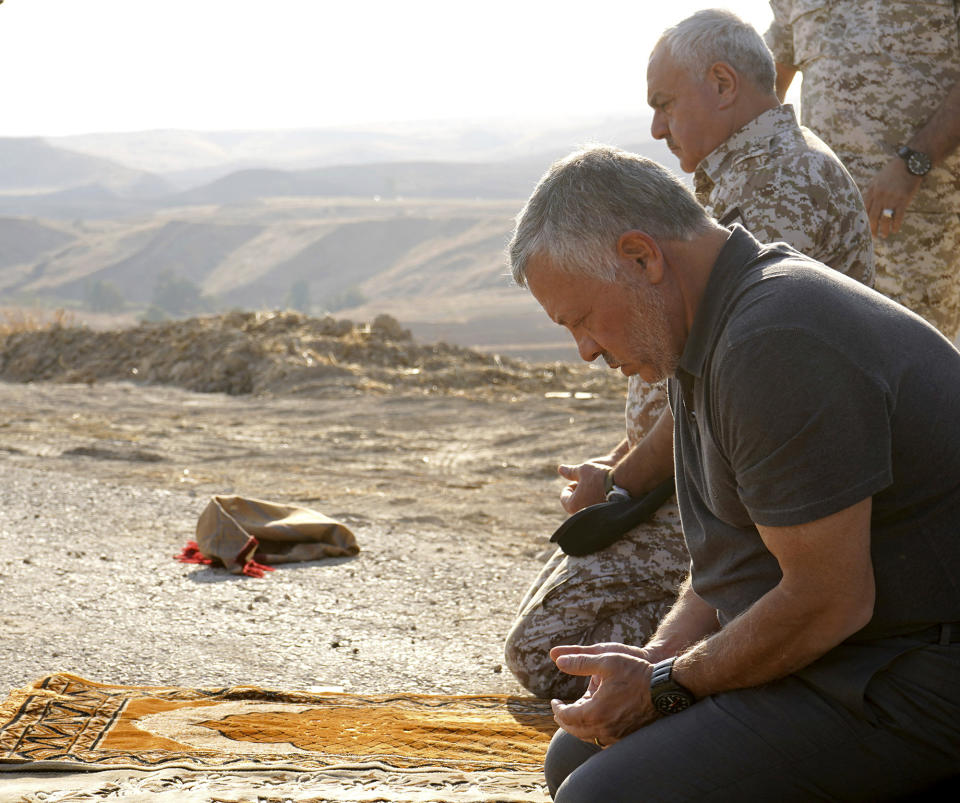 Jordan’s King Abdullah II, right, prays during a tour of the Baqura enclave formerly leased by Israel, Monday, Nov. 11, 2019. Jordan’s decision not to renew the leases on the Baqura and Ghamr enclaves, known in Hebrew as Naharayim and Tzofar, were a fresh blow to Israel and Jordan’s rocky relations 25 years after the two countries signed a peace deal. (Yousef Allan/Jordanian Royal Court via AP)