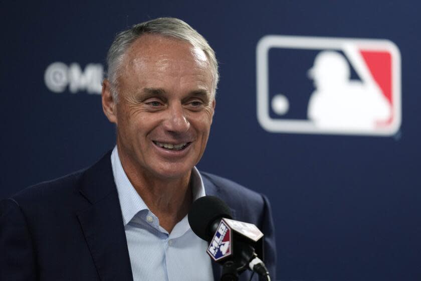 FILE - Major League Baseball commissioner Rob Manfred speaks during a baseball spring training media day Thursday, Feb. 15, 2024, in Tampa, Fla. "Clearly having a very high payroll is correlated with winning more games in the regular season," Manfred said Tuesday, March 19, 2024. "The saving grace for us has been that our playoffs are unpredictable enough that the 110-win team doesn't automatically march through the playoffs. That's why I reacted probably too negatively to the criticism that the playoffs were unpredictable and the best teams weren't coming through. The fact of the matter is that's a good thing for us over the long haul."(AP Photo/Charlie Neibergall, File)