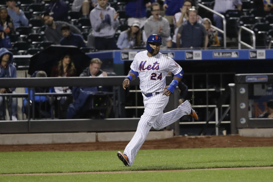 New York Mets' Robinson Cano (24) runs to home plate to score on a RBI single by Michael Conforto during the fourth inning of a baseball game against the Miami Marlins Saturday, May 11, 2019, in New York. (AP Photo/Frank Franklin II)